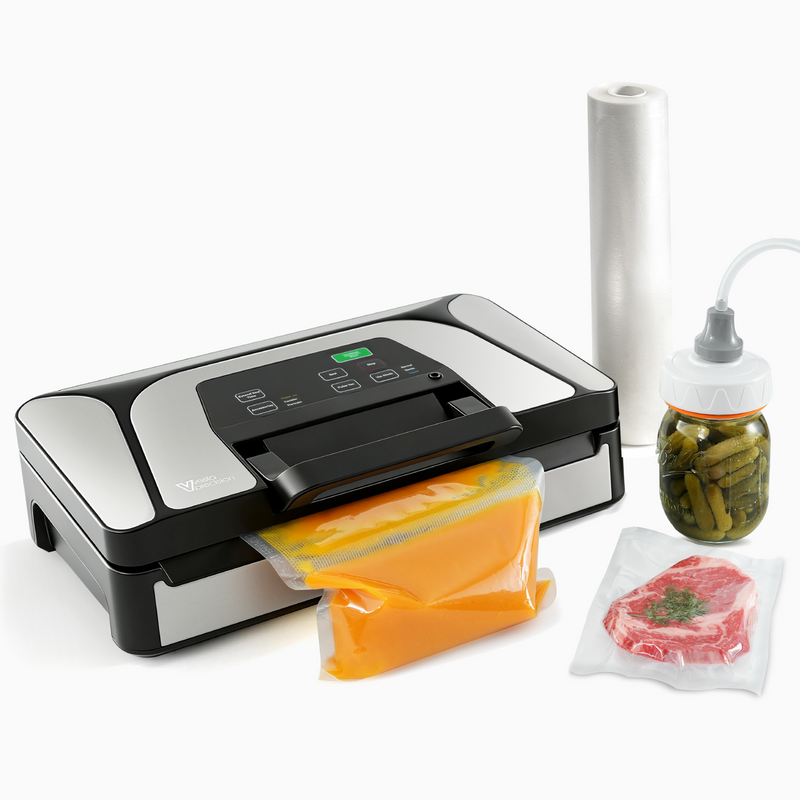 A picture of the black and silver V22 vacuum sealer with a roll, mason jar, and vacuum bags containing food.