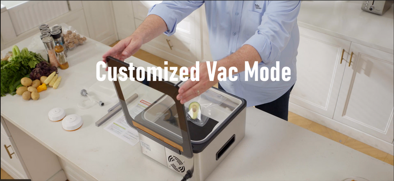A man is placing a bag of food into chamber vacuum sealer with the title 'Customized Vac Mode'.