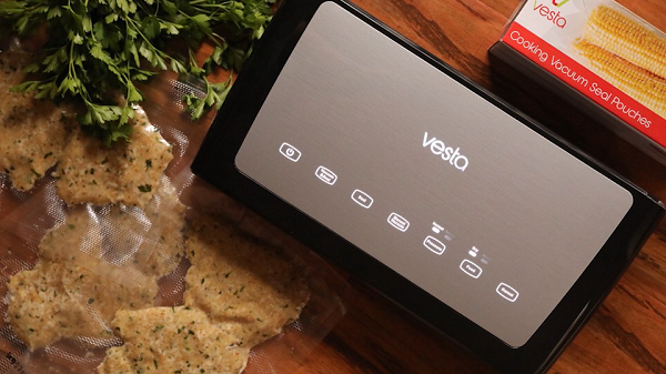 Vacuum Sealer on wooden table with food