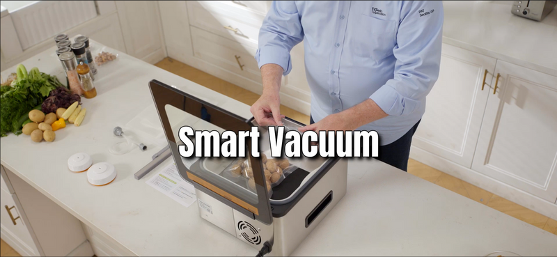 A man placing bagged food inside a chamber vacuum sealer.