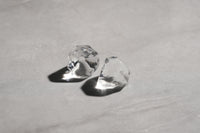 A picture of two large clear ice diamond shapes.