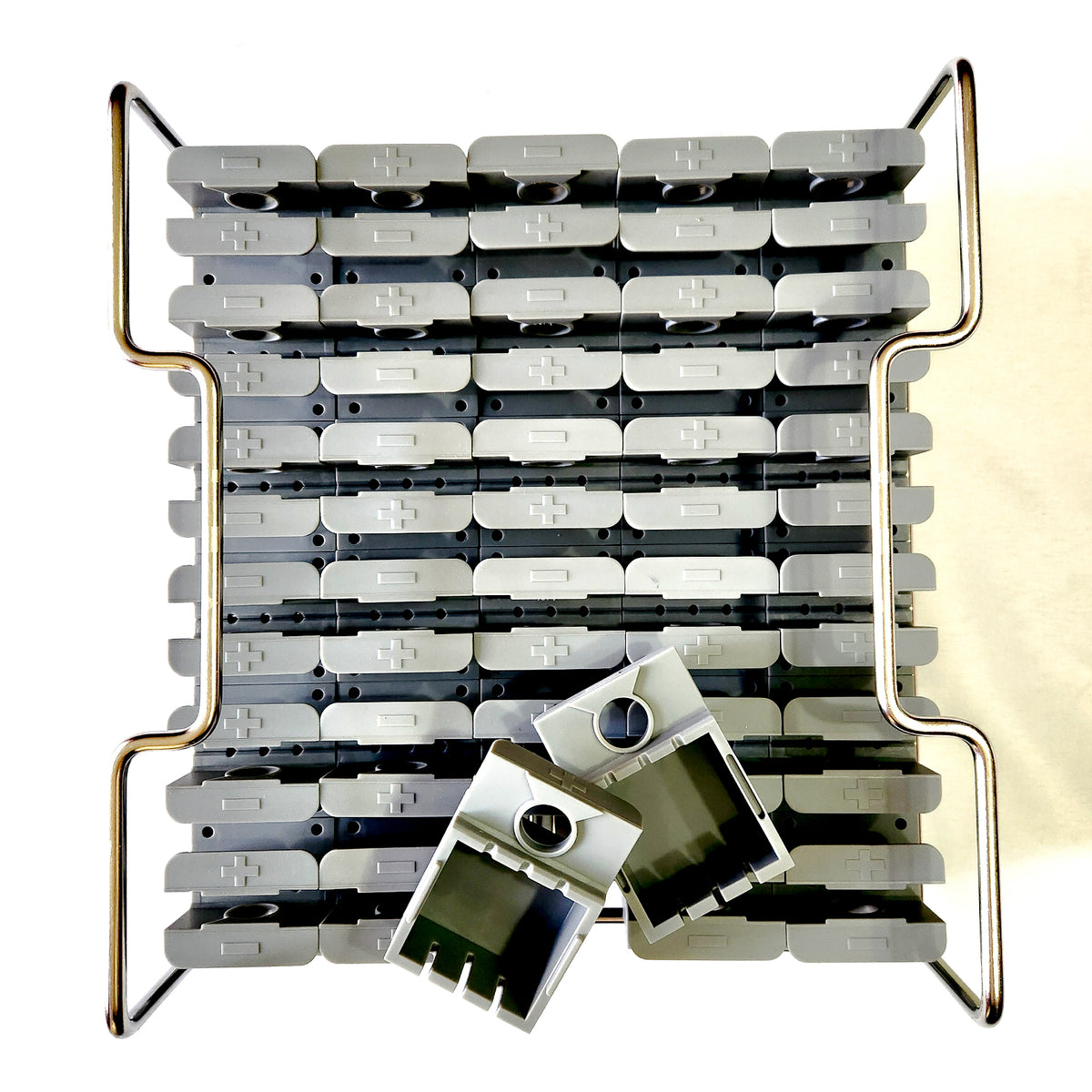 A picture of the light grey 55mm cube ice molds and stainless steel frame.