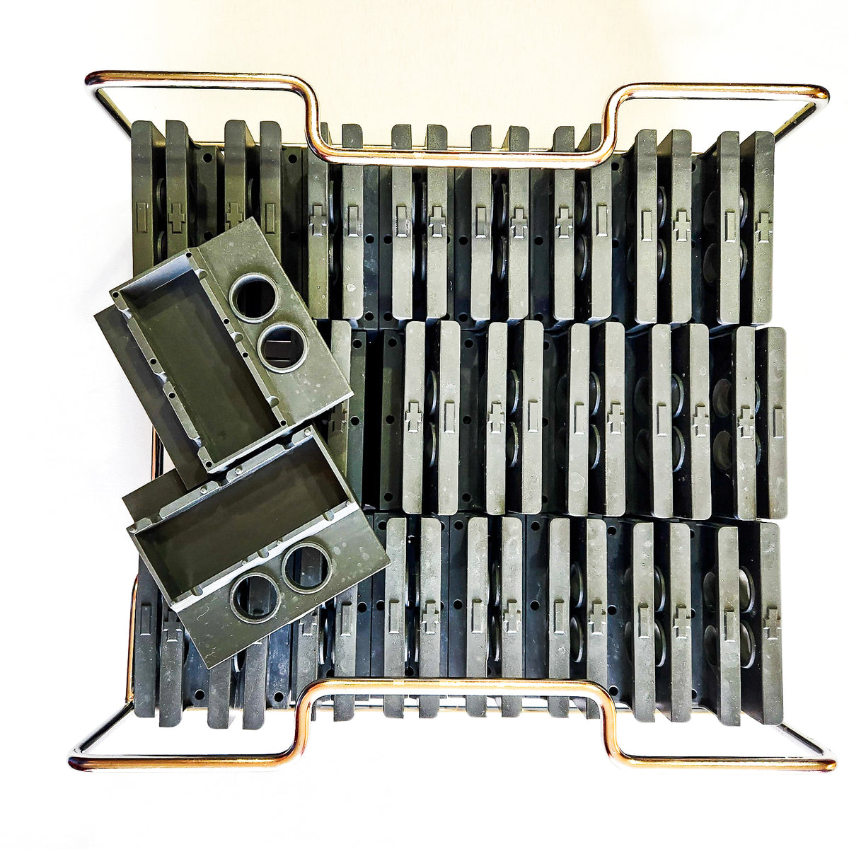 A picture of the dark grey Collins spear ice molds and the stainless steel frame.