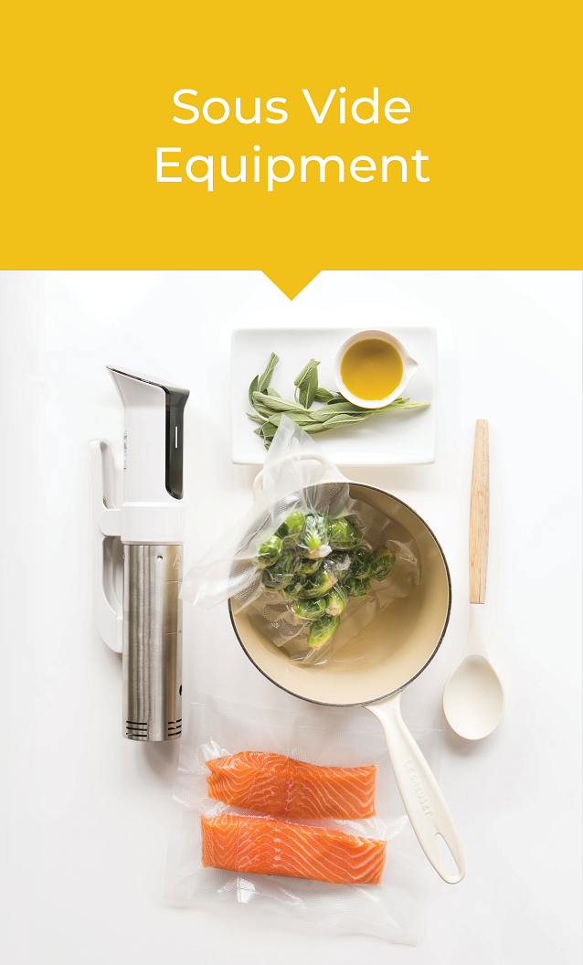 An overhead view of a sous vide immersion circulator with soup in a bowl, vacuum sealed salmon filets, and a small cup of sauce