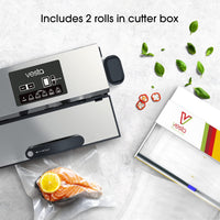 A top-down picture of a vacuum sealer with a bag containing salmon next to a cutter box for a vacuum seal roll.