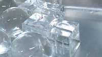 A picture of large clear ice spheres and cubes.